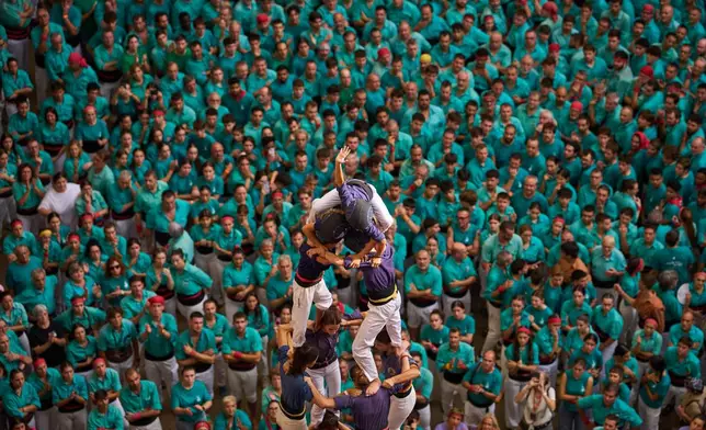 Members of Castellers Jove de Tarragona form a "castell," or human tower, during the 30th Concurs de Castells, or Human Tower Competition, in Tarragona, Spain, Sunday, Oct. 4, 2026. (AP Photo/Emilio Morenatti)