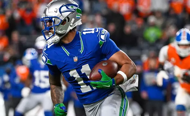 Seattle Seahawks wide receiver Jaxon Smith-Njigba runs the ball against the Denver Broncos during the second half of an NFL football game in Denver, Thursday, Oct. 15, 2026. (AP Photo/Geneva Heffernan)