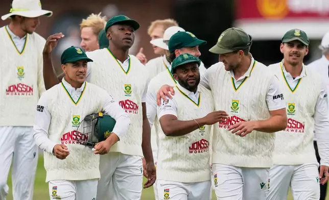 South Africa's captain Temba Bavuma, center right, celebrates with teammates after winning the second cricket test match between South Africa and Australia, in Gqeberha, South Africa, Thursday, Oct. 22, 2026. (AP Photo/Themba Hadebe)