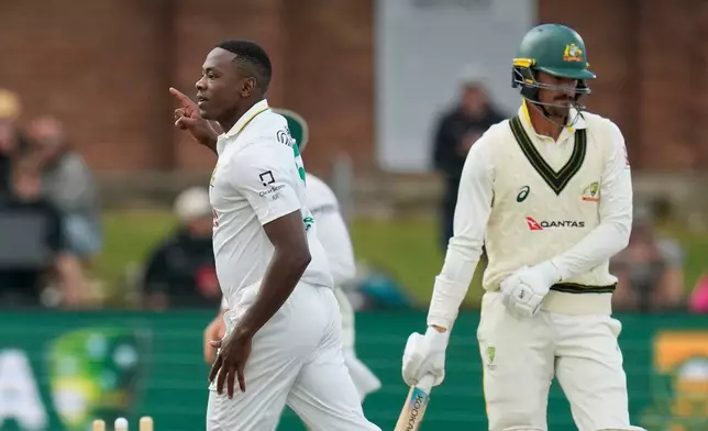 South Africa's Kagiso Rabada, left, celebrates the wicket of Australia's Mitchell Starc, right, on day five of the second cricket test match between South Africa and Australia, in Gqeberha, South Africa, Thursday, Oct. 22, 2026. (AP Photo/Themba Hadebe)