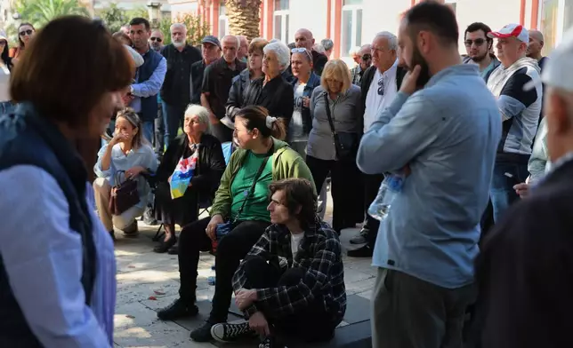 Demonstrators gather near the entrance of Georgia's Constitutional Court as it hears a lawsuit by the ruling Georgian Dream party to ban five major opposition parties in Batumi, Georgia, Wednesday, Oct. 21, 2026. (AP Photo/Zurab Tsertsvadze)