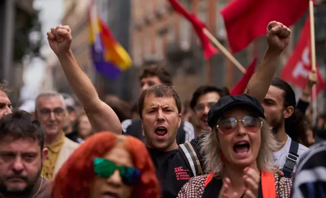 Activists protest near the Spanish Parliament following the eviction of 87-year-old Maricarmen to demand stronger laws to protect renters in Madrid, Spain, Friday, Oct. 2, 2026. (AP Photo/Manu Fernandez)