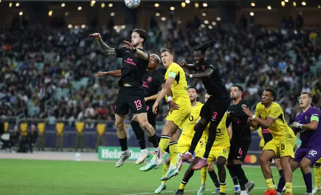 Sabah's Ivan Lepinjica, left, jumps for the ball during the Champions League opening phase soccer match between Sabah FK and Borussia Dortmund in Baku, Azerbaijan, Tuesday, Oct. 20, 2026. (AP Photo)