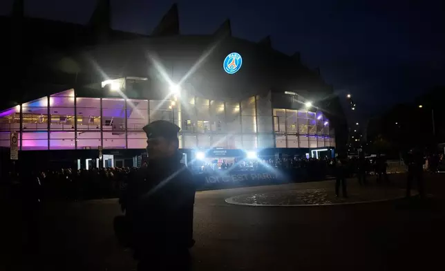 Police officers stand guard outside the stadium ahead of the Champions League opening phase soccer match between Paris Saint-Germain and FC Barcelona in Paris, Tuesday, Oct. 20, 2026. (AP Photo/Teresa Suarez)