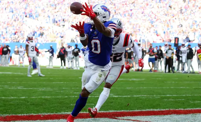 Buffalo Bills wide receiver Keon Coleman (0) makes a catch for a touchdown against New England Patriots cornerback Charles Woods (22) in the second half during an NFL football game in Orchard Park, N.Y., Sunday, Oct. 4, 2026. (AP Photo/Jeffrey T. Barnes)