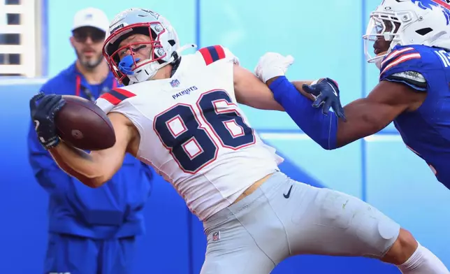 New England Patriots wide receiver Efton Chism III (86) makes a catch to score a touchdown against Buffalo Bills cornerback Davison Igbinosun (21) in the second half during an NFL football game in Orchard Park, N.Y., Sunday, Oct. 4, 2026. (AP Photo/Jeffrey T. Barnes)