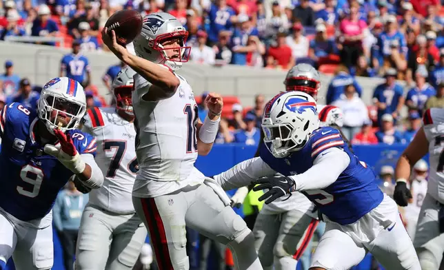 New England Patriots quarterback Drake Maye (10) passes against Buffalo Bills linebacker Greg Rousseau (15) in the second half during an NFL football game in Orchard Park, N.Y., Sunday, Oct. 4, 2026. (AP Photo/Jeffrey T. Barnes)