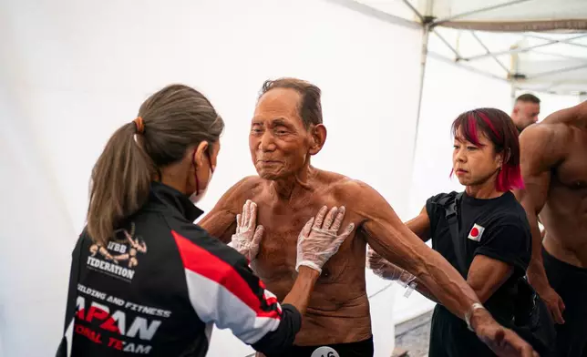 Japanese bodybuilder Toshisuke Kanazawa, 90, prepares to compete in the 2026 IFBB World Fitness and Bodybuilding Championships in Santa Susanna, Spain, Friday, Oct. 30, 2026. (AP Photo/Pau Venteo)