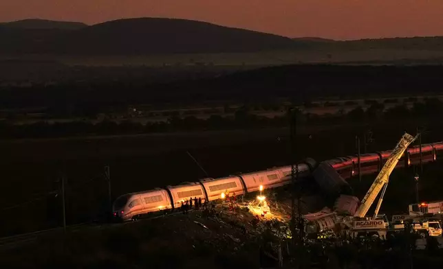 Emergency services work at the scene of a collision between two trains in Urda, Spain, on Wednesday, Oct. 28, 2026. (AP Photo/Manu Fernandez)