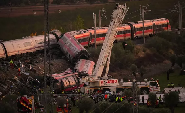 Emergency services work at the scene of a collision between two trains in Urda, Spain, on Wednesday, Oct. 28, 2026. (AP Photo/Manu Fernandez)
