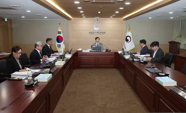 In this photo provided by the Korea Media and Communications Commission (KMCC), KMCC chairperson Kim Jong-cheol, center, speaks during a meeting at the government complex in Gwacheon, South Korea, Wednesday, Oct. 28, 2026. (The Korea Media and Communications Commission via AP)