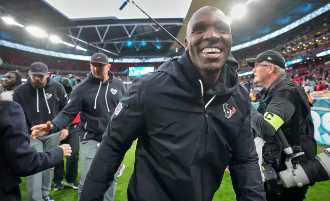 Houston Texans head coach DeMeco Ryans smiles as he leaves the field after an NFL football game against Jacksonville Jaguars in London, Sunday, Oct. 18, 2026. (AP Photo/Kin Cheung)