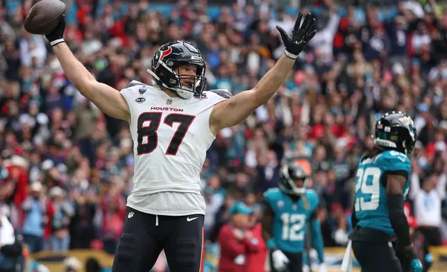 Houston Texans tight end Foster Moreau (87) celebrates after scoring the first touchdown during an NFL football game against Jacksonville Jaguars in London, Sunday, Oct. 18, 2026. (AP Photo/Ian Walton)