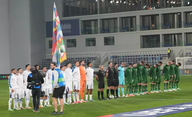 Irish players bow their heads during Israeli national anthem before the UEFA Nations League soccer match between the Republic of Ireland and Israel in Backa Topola, Serbia, Sunday, Oct. 4, 2026. (AP Photo/Darko Vojinovic)