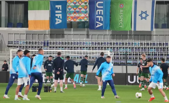 Israeli and Irish players warm-up for the UEFA Nations League soccer match between the Republic of Ireland and Israel in Backa Topola, Serbia, Sunday, Oct. 4, 2026. (AP Photo/Darko Vojinovic)
