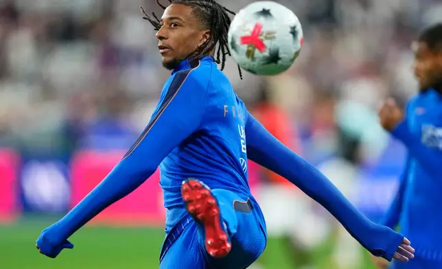 France's Michael Olise warms up prior to the Nations League soccer match between France and Belgium in Saint-Denis near Paris, Monday, Oct. 5, 2026. (AP Photo/Teresa Suarez)
