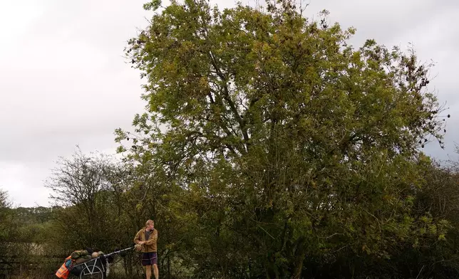 British adventurer Karl Bushby walks near Market Rasen, Lincolnshire, England, Wednesday, Oct. 28, 2026, on the final stretch of his 28-year walk around the world to get back to his mother's home in Hull. (AP Photo/Brian Melley)