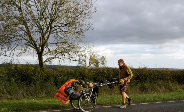 British adventurer Karl Bushby walks near Market Rasen, Lincolnshire, England, Wednesday, Oct. 28, 2026, on the final stretch of his 28-year walk around the world to get back to his mother's home in Hull. (AP Photo/Brian Melley)