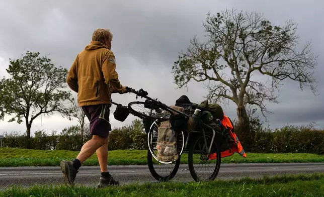 British adventurer Karl Bushby walks near Market Rasen, Lincolnshire, England, Wednesday, Oct. 28, 2026, on the final stretch of his 28-year walk around the world to get back to his mother's home in Hull. (AP Photo/Brian Melley)