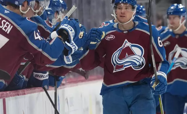 Colorado Avalanche left wing Artturi Lehkonen is congratulated as he passes the team box after scoring a goal against the Pittsburgh Penguins in the second period of an NHL hockey game, Friday, Oct. 16, 2026, in Denver. (AP Photo/David Zalubowski)