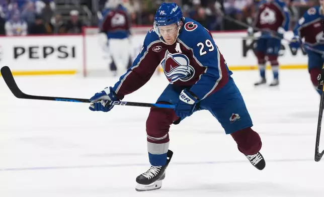 Colorado Avalanche center Nathan MacKinnon drives downice in the first period of an NHL hockey game against the Pittsburgh Penguins, Friday, Oct. 16, 2026, in Denver. (AP Photo/David Zalubowski)