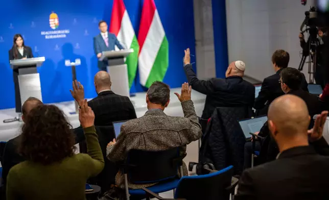 FILE - Journalists ask questions to Gergely Gulyás, Minister of the Prime Minister's Office enters the press room during the government's press conference on Thursday, Jan 18, 2024. (AP Photo/Denes Erdos, File)