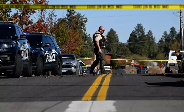 A sheriff's deputy walks outside Silver Rail Elementary school, where a shooting took place, on Thursday, Oct. 15, 2026 in Bend, Ore. (AP Photo/Joe Kline)