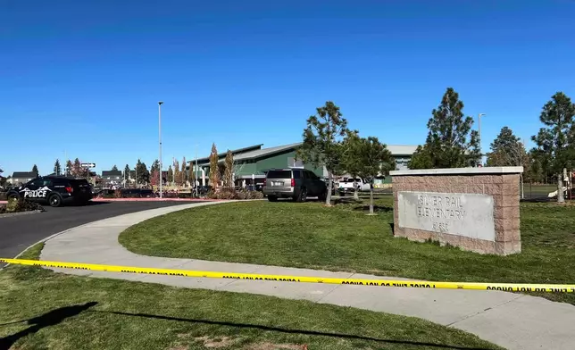 Police tape is placed outside Silver Rail Elementary school, where a shooting took place, on Thursday, Oct. 15, 2026 in Bend, Ore. (AP Photo/Joe Kline)