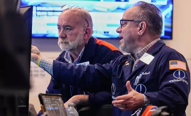FILE - Traders Joseph Stevens, left, and Robert Arciero work on the floor of the New York Stock Exchange, Monday, Feb. 2, 2026. (AP Photo/Richard Drew, file)