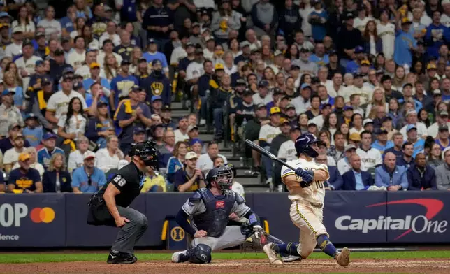 Milwaukee Brewers right fielder Sal Frelick follows through on a solo home run during the sixth inning of Game 2 of baseball's World Series, Saturday, Oct. 24, 2026, in Milwaukee, between the Milwaukee Brewers and the Tampa Bay Rays. (AP Photo/Ashley Landis)