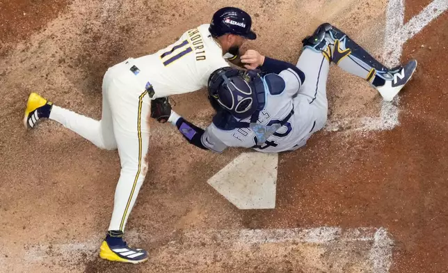Milwaukee Brewers' Jackson Chourio is tagged out at the plate by Tampa Bay Rays catcher Nick Fortes during the eighth inning of Game 2 of baseball's World Series, Saturday, Oct. 24, 2026, in Milwaukee, between the Milwaukee Brewers and the Tampa Bay Rays. (AP Photo/David J. Phillip)
