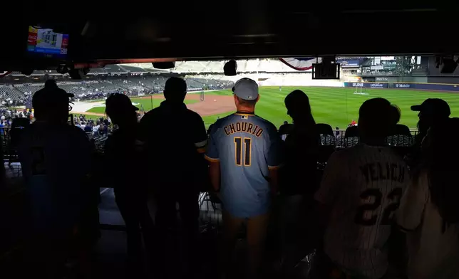 Fans watch batting practice before Game 2 of baseball's World Series, Saturday, Oct. 24, 2026, in Milwaukee, between the Milwaukee Brewers and the Tampa Bay Rays. (AP Photo/David J. Phillip)