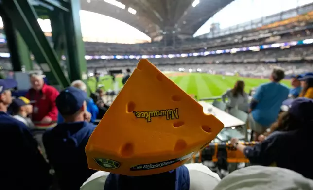 Fans watch during batting practice before Game 1 of baseball's World Series, Friday, Oct. 23, 2026, in Milwaukee, between the Milwaukee Brewers and the Tampa Bay Rays. (AP Photo/David J. Phillip)
