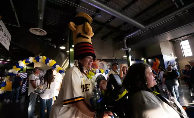 Fans arrive for Game 2 of baseball's World Series, Saturday, Oct. 24, 2026, in Milwaukee, between the Milwaukee Brewers and the Tampa Bay Rays. (AP Photo/David J. Phillip)