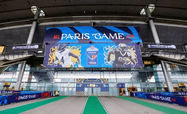An exterior view of the Stade de France with NFL branding on Thursday, Oct. 22, 2026, in Saint-Denis, north of Paris, ahead of Sunday's game between the Pittsburgh Steelers and the New Orleans Saints. (AP Photo/Greg Payan)