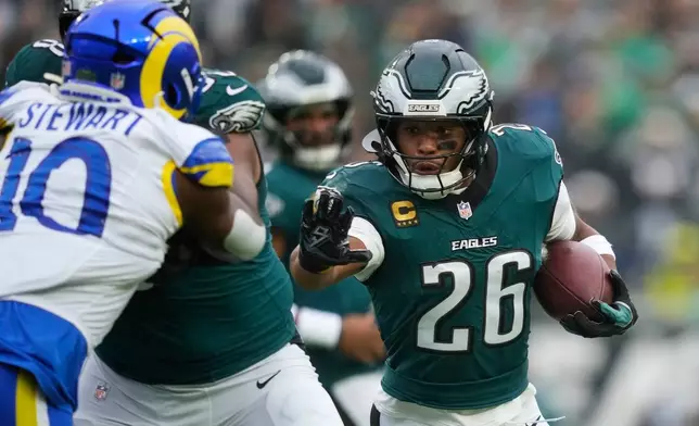 Philadelphia Eagles running back Saquon Barkley (26) runs with the ball during the first half of an NFL football game against the Los Angeles Rams in Philadelphia, Sunday, Oct. 4, 2026. (AP Photo/Matt Slocum)