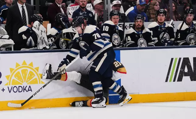 Columbus Blue Jackets defenseman Damon Severson (78) checks Vegas Golden Knights center Brett Howden (21) into the board during the second period of an NHL hockey game Saturday, Oct. 24, 2026, in Columbus, Ohio. (AP Photo/Joshua A. Bickel)