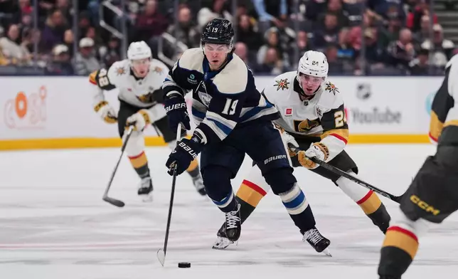 Columbus Blue Jackets center Adam Fantilli (19) controls the puck in front of Vegas Golden Knights left wing Trevor Connelly (24) during the second period of an NHL hockey game Saturday, Oct. 24, 2026, in Columbus, Ohio. (AP Photo/Joshua A. Bickel)
