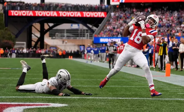 New England Patriots wide receiver Kyle Williams (18) catches a touchdown pass against Las Vegas Raiders cornerback Hezekiah Masses (35) during an NFL football game in Foxborough, Mass., Sunday, Oct. 11, 2026. (AP Photo/Charles Krupa)