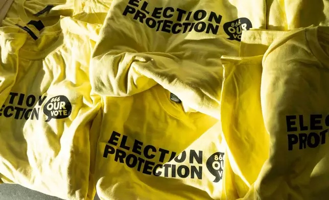 T-shirts are ready to be handed out to newly-trained poll chaplains and peacekeepers during a training, Tuesday, Oct. 6, 2026, ahead of the upcoming general midterm election, at Temple Chai in Scottsdale, Ariz. (AP Photo/Rebecca Noble)
