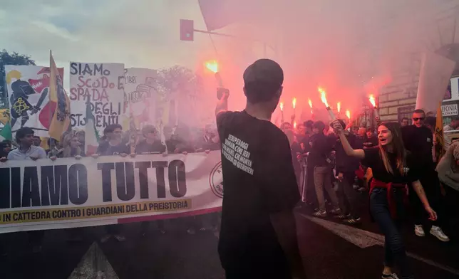 Members of right-wing student groups march through the streets of Rome during a demonstration called "Unlock Everything," organized in opposition to recent left-wing student protests and one of several demonstrations held by groups across the political spectrum, Saturday, Oct. 24, 2026. (AP Photo/Gregorio Borgia)