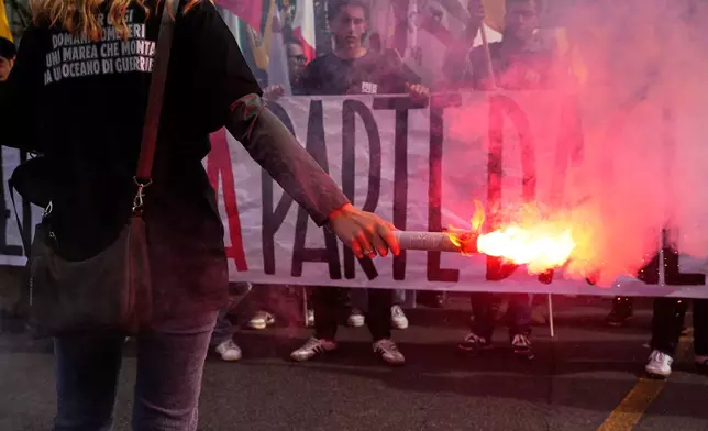 Members of right-wing student groups march through the streets of Rome, Saturday, Oct. 24, 2026, during a demonstration called "Unlock Everything," organized in opposition to recent left-wing student protests and one of several demonstrations held by groups across the political spectrum. (AP Photo/Gregorio Borgia)