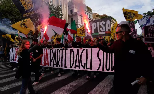 Members of right-wing student groups march through the streets of Rome, Saturday, Oct. 24, 2026, during a demonstration called "Unlock Everything," organized in opposition to recent left-wing student protests and one of several demonstrations held by groups across the political spectrum. (AP Photo/Gregorio Borgia)
