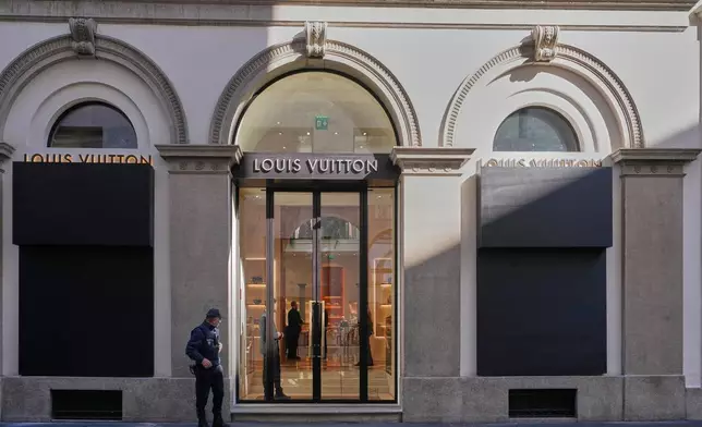 Shop windows are boarded up in Milan, Saturday, Oct. 24, 2026, ahead of a protest against the rising cost of living and deteriorating public services, one of several demonstrations organized across Italy by groups spanning the political spectrum. (AP Photo/Antonio Calanni)