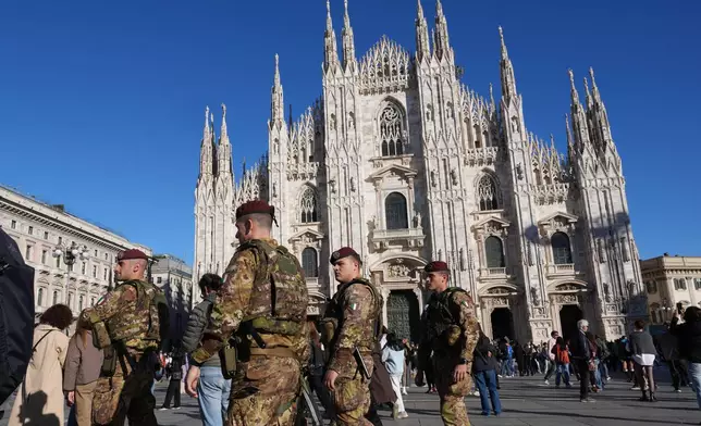 Italian army paratroopers patrol the area around Milan's Duomo Cathedral, Italy, Saturday, Oct. 24, 2026, ahead of expected protests against the rising cost of living and deteriorating public services during one of several protests in Italy organized by groups across the political spectrum. (AP Photo/Antonio Calanni)