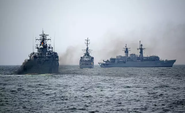FILE - Romanian warships sail engulfed in smoke during a Romanian Navy led exercise outside Constanta, Romania, on April 16, 2024. (AP Photo/Andreea Alexandru, File)