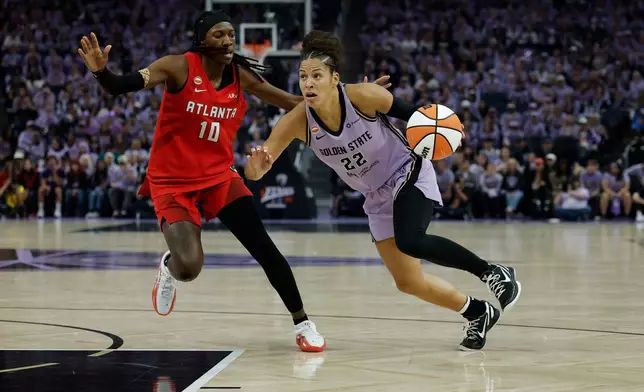 Golden State Valkyries guard Veronica Burton (22) moves the ball while defended by Atlanta Dream guard Rhyne Howard (10) during the second half of Game 2 of the WNBA basketball finals in San Francisco, Monday, Oct. 19, 2026. (Carlos Avila Gonzalez/San Francisco Chronicle via AP)
