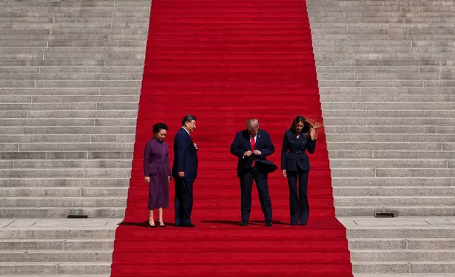 President Donald Trump, center right, first lady Melania Trump, right, China's President Xi Jinping, center left, and his wife Peng Liyuan prepare to pose for a photo on the steps of the National Archives Museum upon arriving, Friday, Sept. 25, 2026, in Washington. (AP Photo/Julia Demaree Nikhinson)