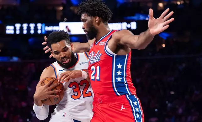 New York Knicks' Karl-Anthony Towns, left, drives to the basket against Philadelphia 76ers' Joel Embiid, right, during the first half of an NBA Cup basketball game, Friday, Oct. 30, 2026, in Philadelphia. (AP Photo/Chris Szagola)