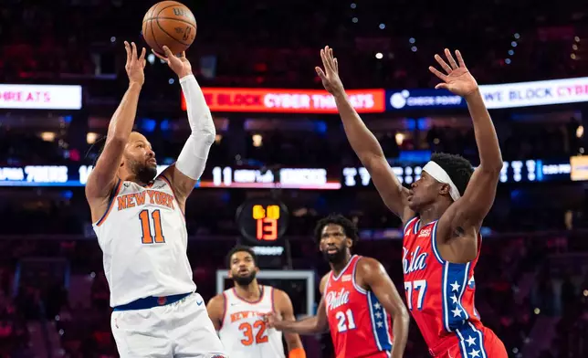 New York Knicks' Jalen Brunson, left, looks to shoot with Philadelphia 76ers' VJ Edgecombe, right, defending during the first half of an NBA Cup basketball game, Friday, Oct. 30, 2026, in Philadelphia. (AP Photo/Chris Szagola)